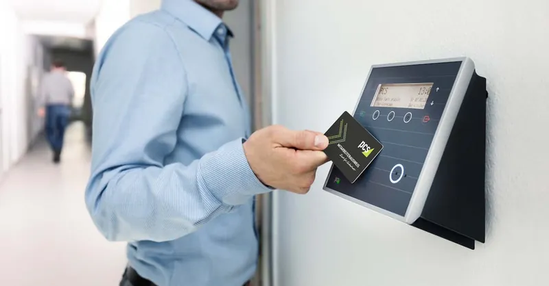 Businessman uses RFID card reader for secure office access, enhancing workplace security.