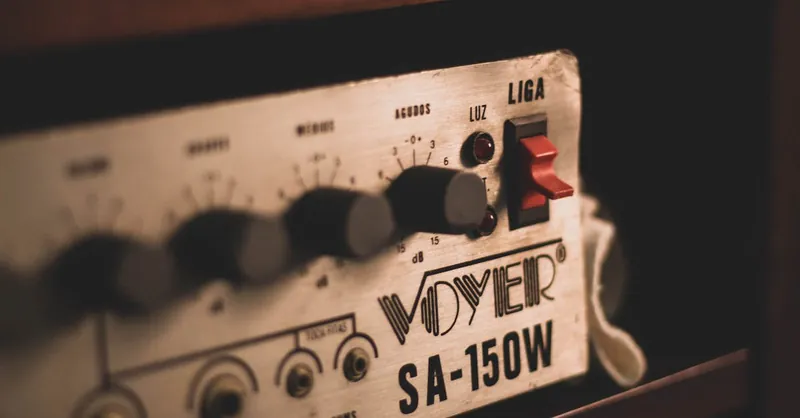Close-up of a vintage audio amplifier with knobs and switches, featuring retro design.