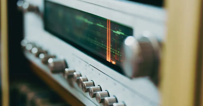 Close-up of an antique radio tuner with knobs and a retro display, evoking a classic analog feel.