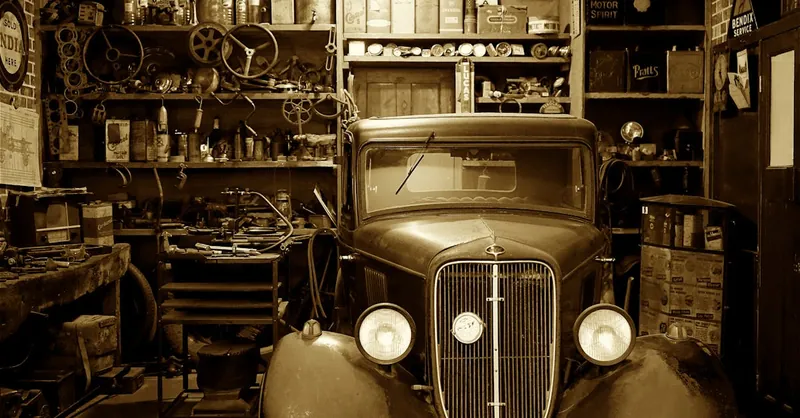 A vintage car surrounded by antique tools and parts in a nostalgic workshop.